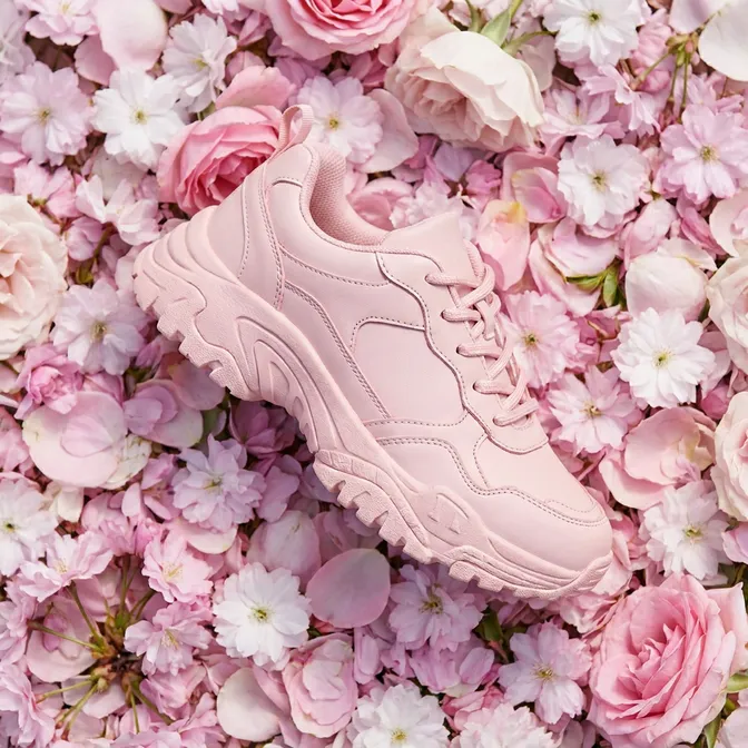 Pink sneakers on a bed of flowers
